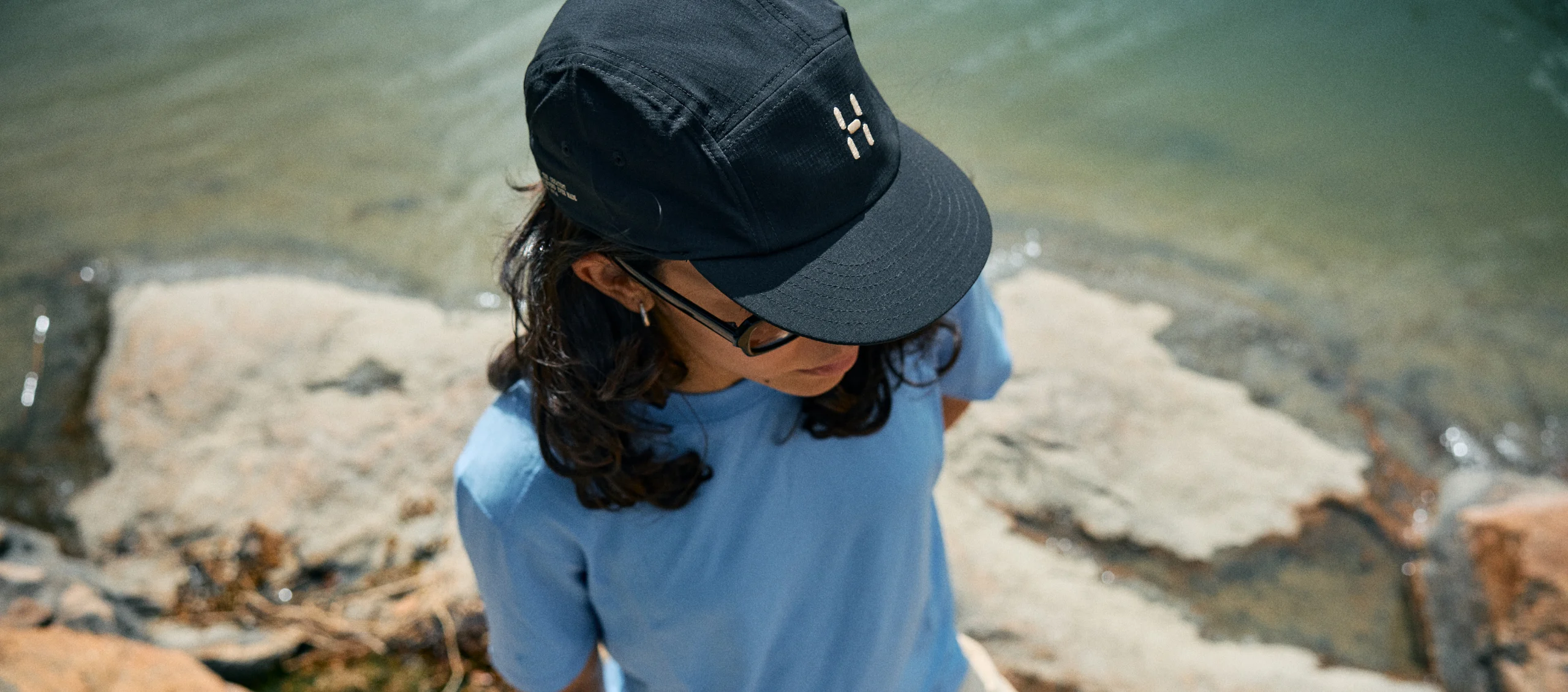 Woman in Haglöfs cap and tshirt during a summer hike