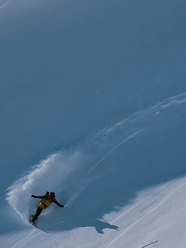 Whitney Gilliam snowboarding down a mountain