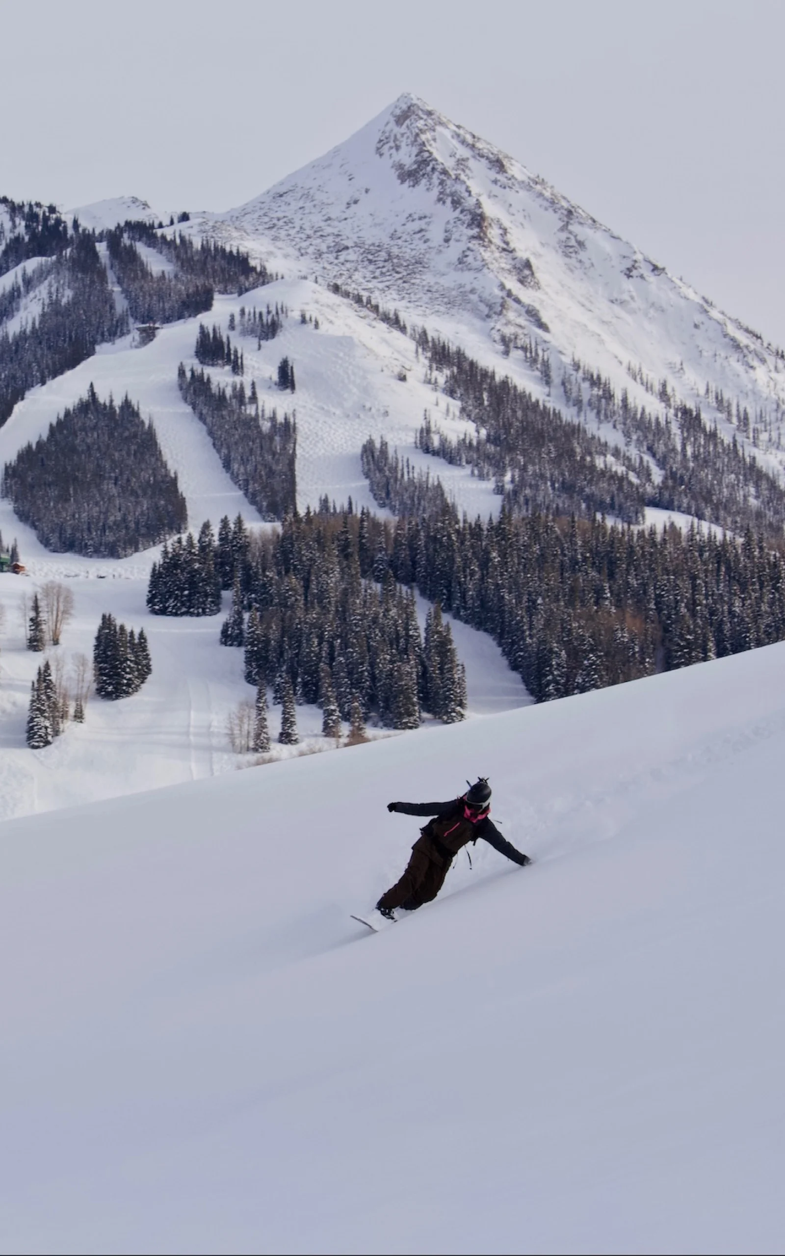 Outsiders by nature Whitney Gilliam snowboarding down a mountain