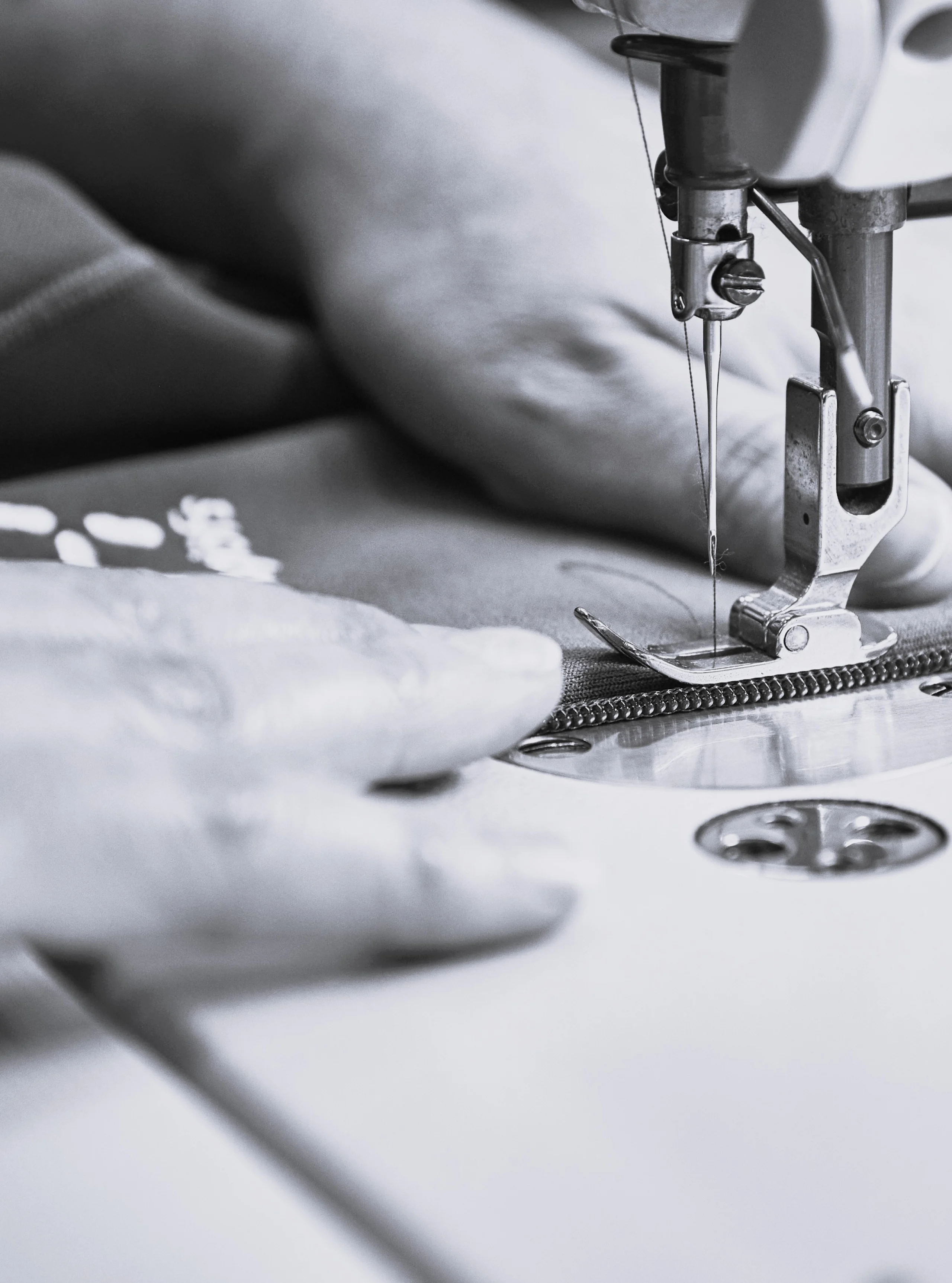 Haglöfs Circular initiatives A person sewing on a sewing machine.