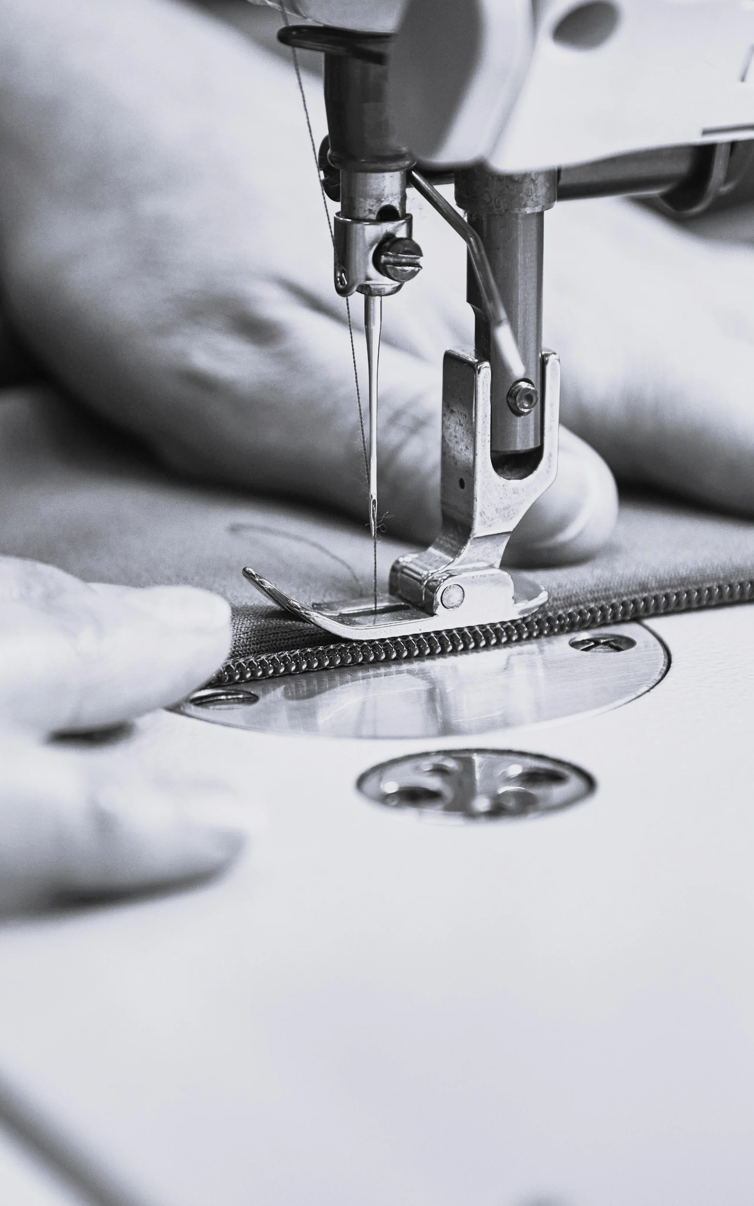 Haglöfs Circular initiatives A person sewing on a sewing machine.