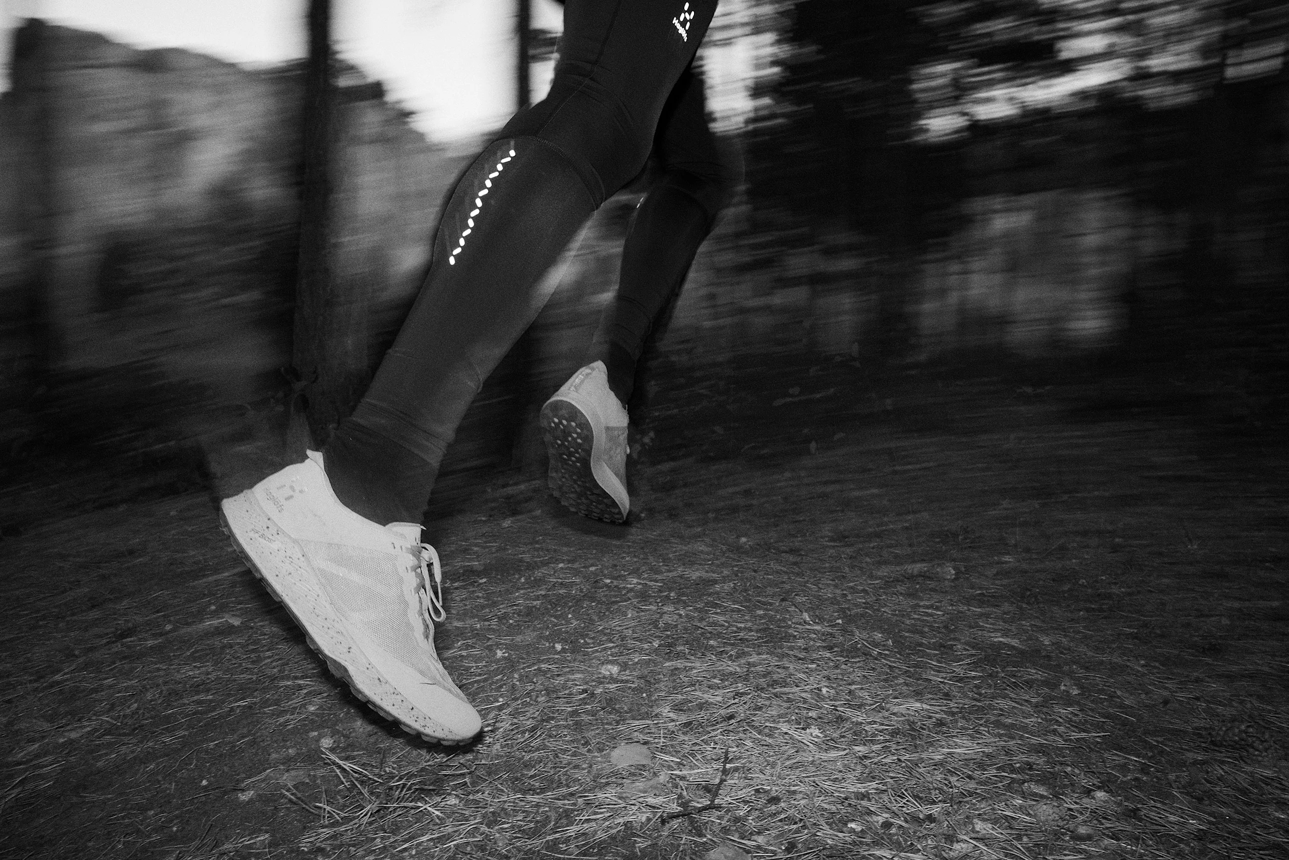 Man outside trail running in the woods.