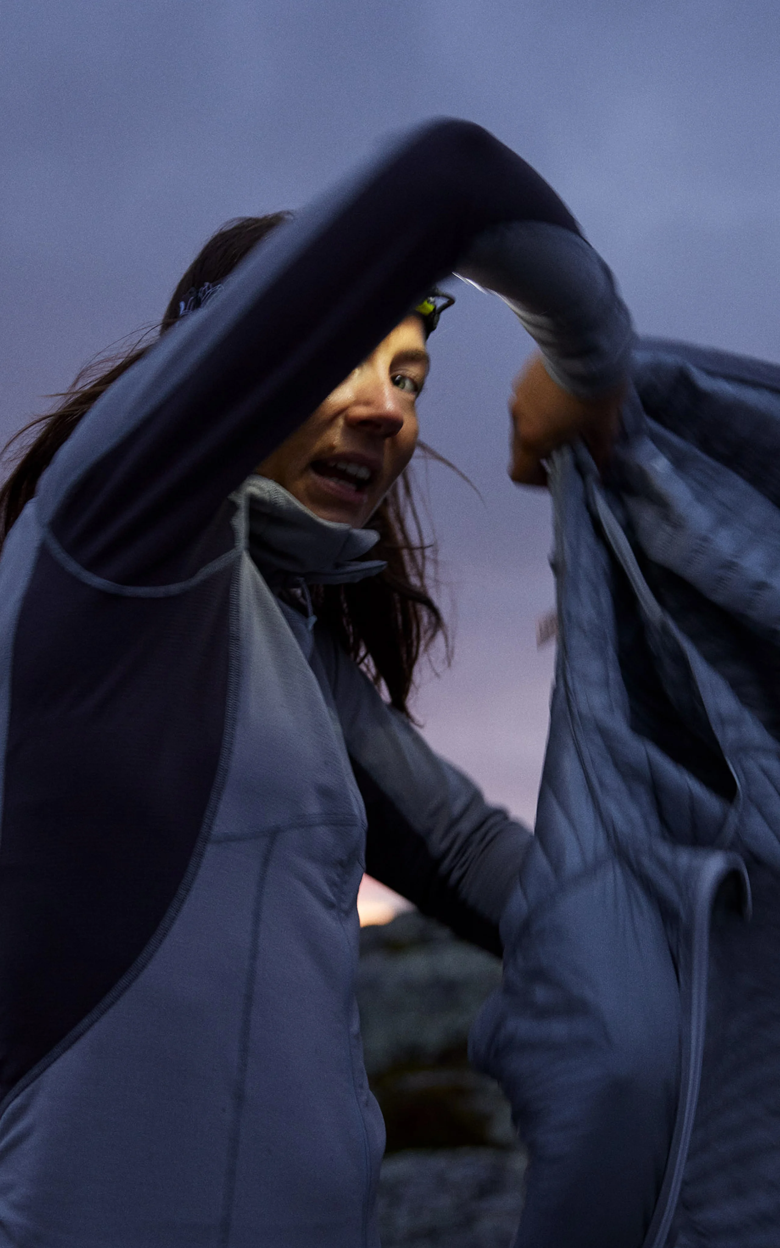 Haglöfs Layering guide Girl puts on her down jacket