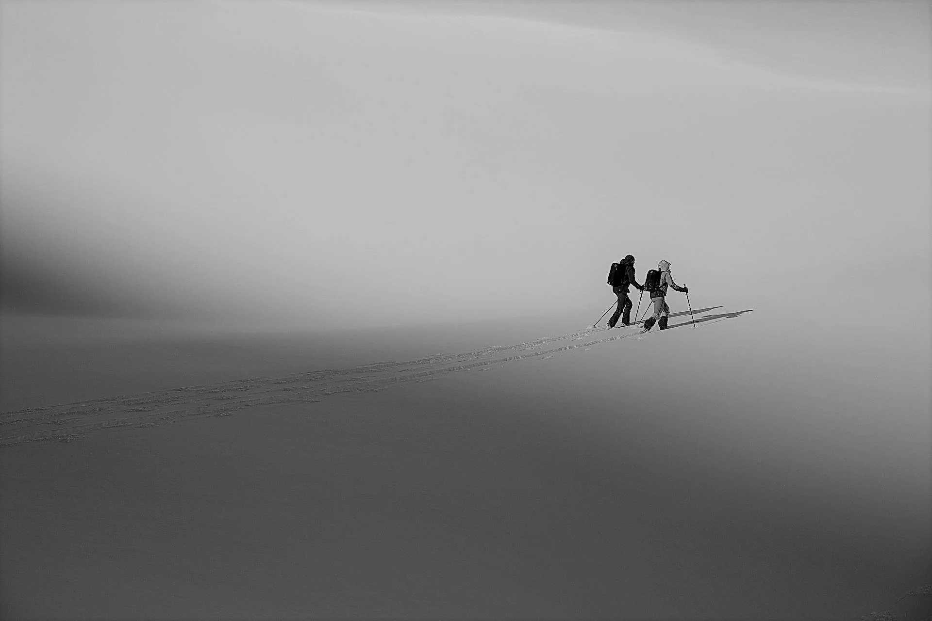 Two people ski touring.