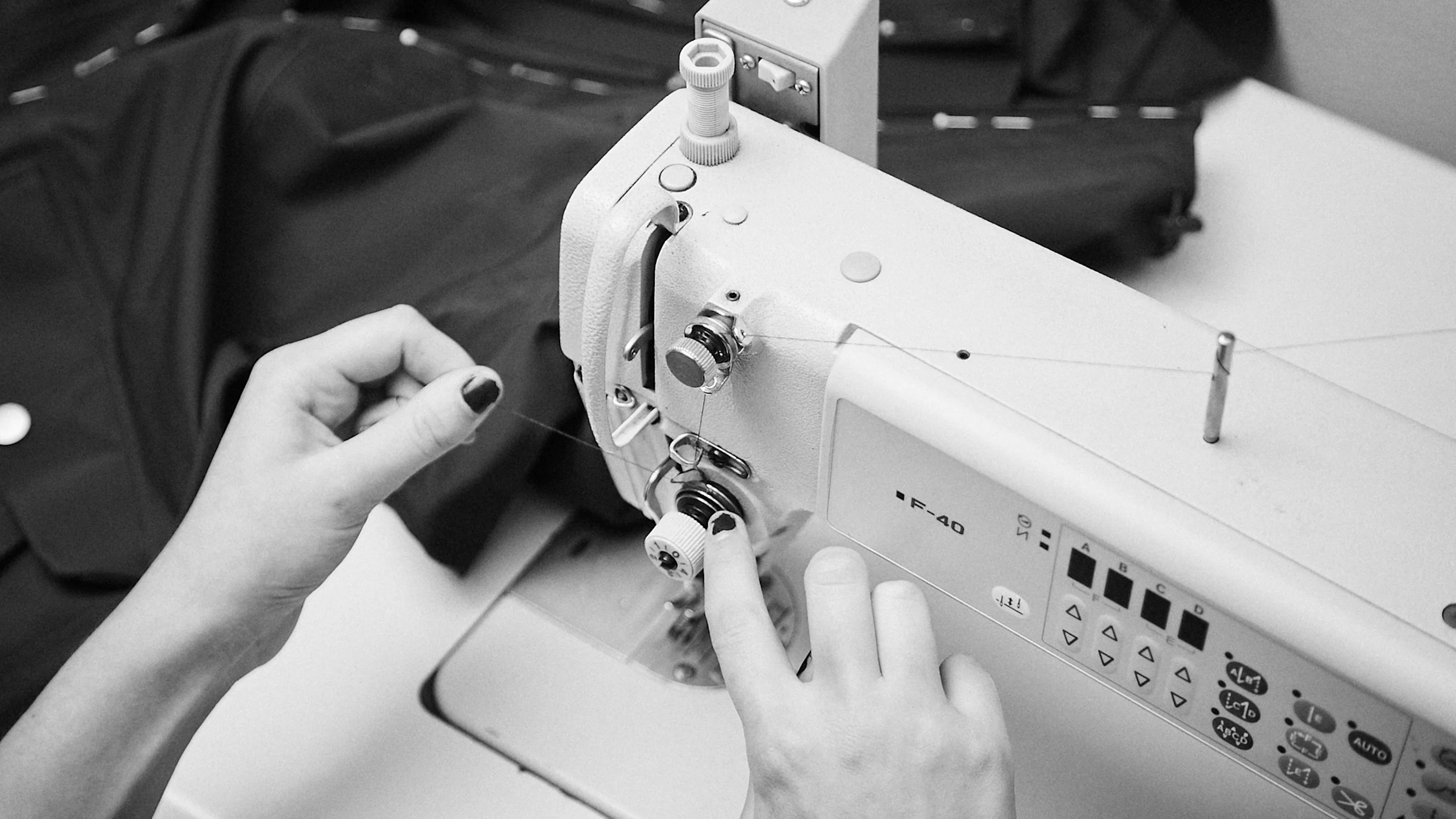 Woman sewing on a sewing machine.