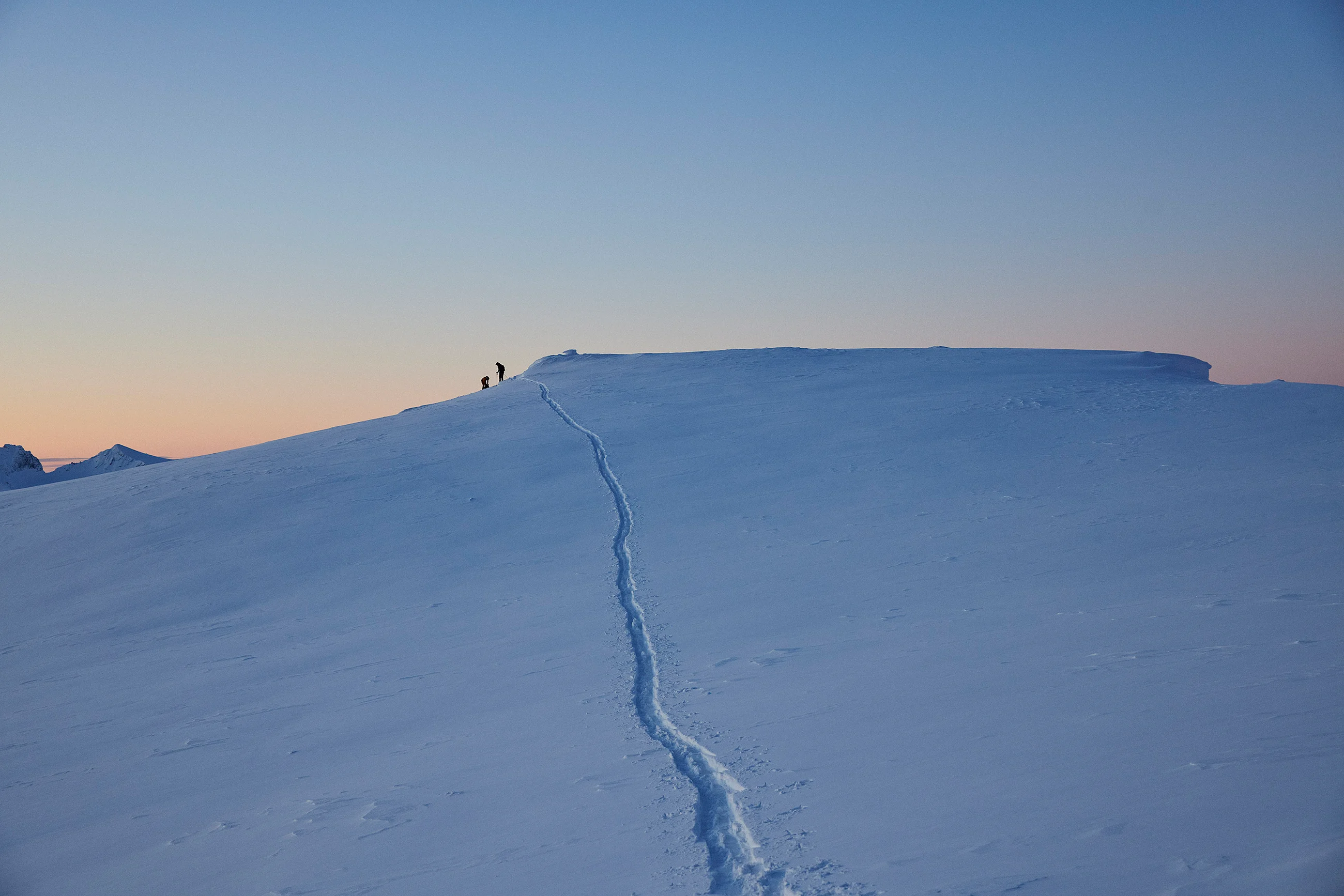People touring in the mountains in the dawn