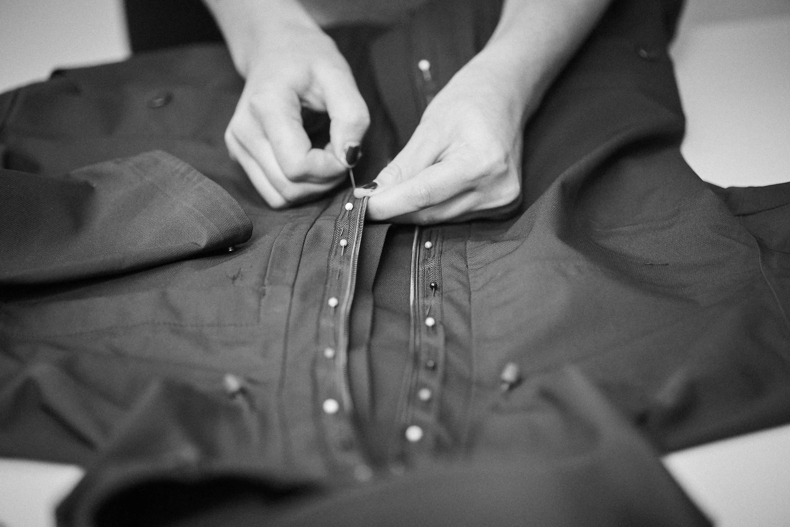 Person pinning up a jacket.